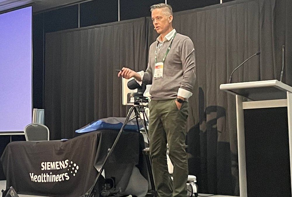 Tristan Reddan presenting on stage at the ASA 2026 conference, Gold Coast.