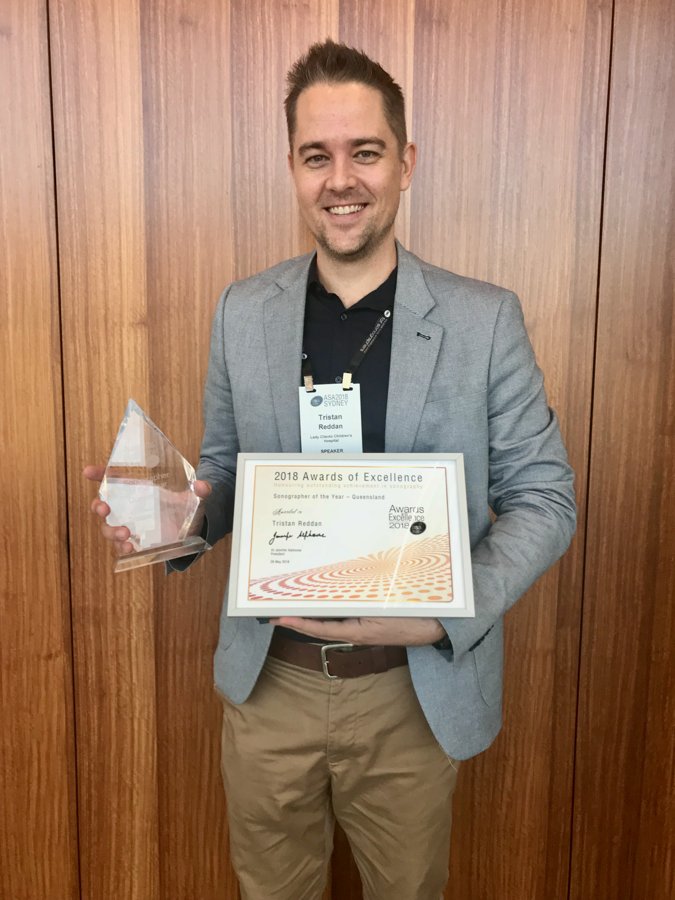 Tristan holding the 2018 Sonographer of the Year, Queensland, trophy and certificate at the ASA conference in Sydney.